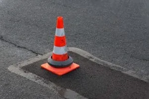 Traffic Cone over a patched pothole