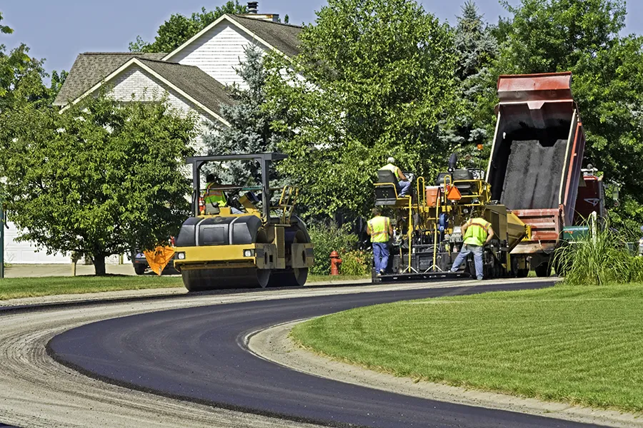 construction workers paving a residential area