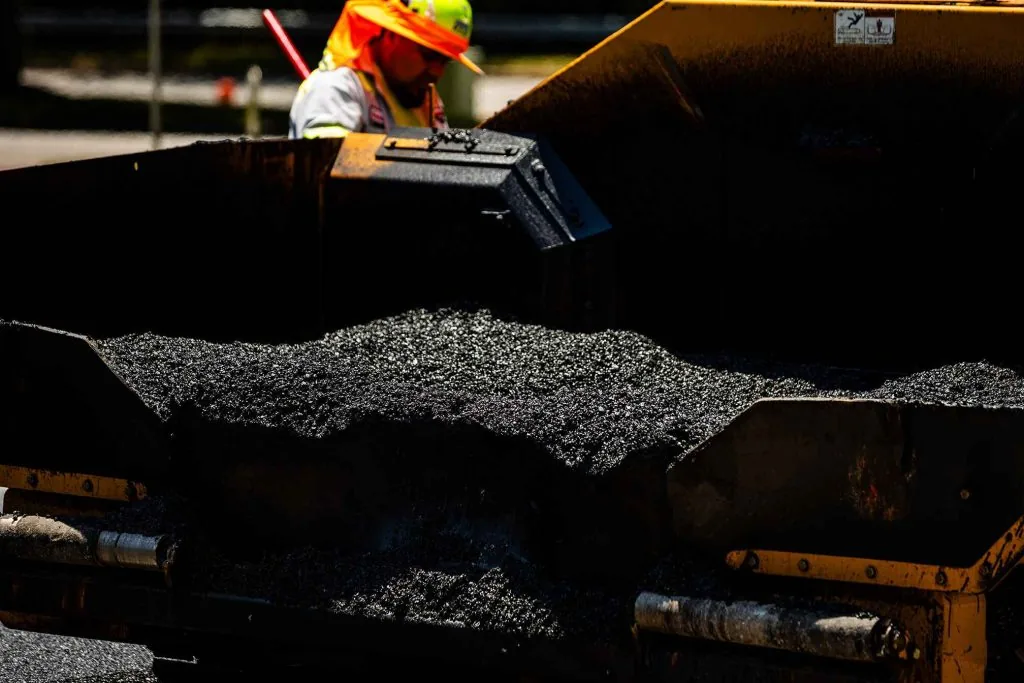 Bed of work truck loaded with fresh asphalt