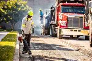 Contractor using a leaf blower