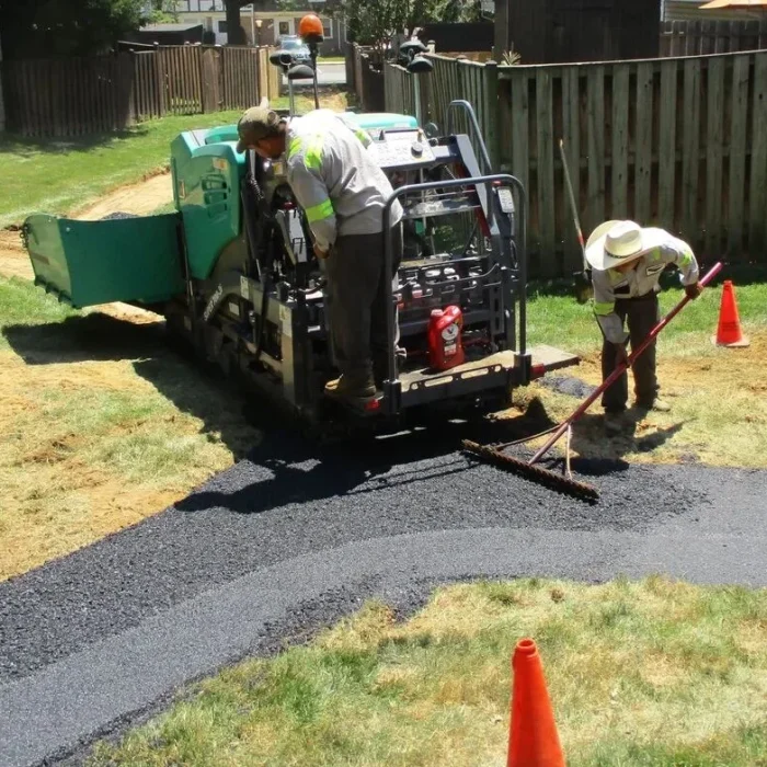 Professional paving services crew installing asphalt