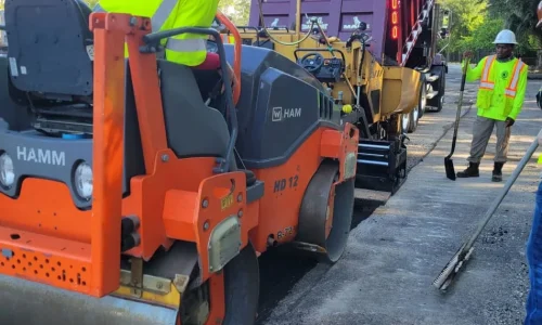 Worker in Truck Laying Asphalt