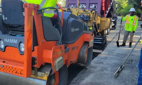 Worker in Truck Laying Asphalt