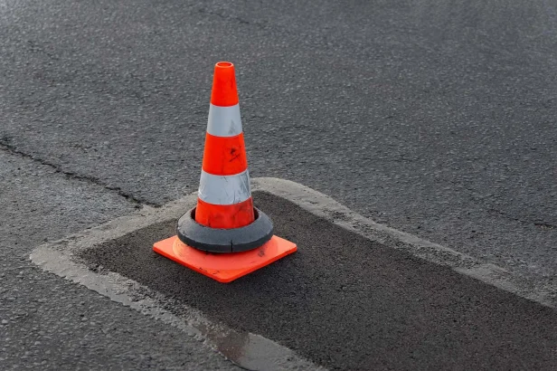 Traffic Cone over a patched pothole